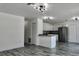 Open-concept home with new floors, stainless steel appliances, white cabinets, and modern lighting fixtures at 4546 Ontario Dr, New Port Richey, FL 34652