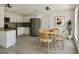 Modern kitchen with stainless steel appliances, white cabinets, gray backsplash and a table with seating at 4546 Ontario Dr, New Port Richey, FL 34652