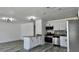 Open-concept kitchen boasts a large island, stainless steel appliances, and adjacent living area at 4546 Ontario Dr, New Port Richey, FL 34652