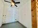 Bright laundry room features a ceiling fan, painted floor, and hookups for a washer and dryer at 4546 Ontario Dr, New Port Richey, FL 34652