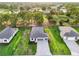 Aerial view displays the neighborhood, golf course, and a lake in the background at 9127 Players Dr, Weeki Wachee, FL 34613