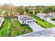 Aerial view showcases landscaping, driveway, and modern exterior of the single Gathering home at 9127 Players Dr, Weeki Wachee, FL 34613