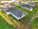 Aerial view of the home displaying a green lawn, modern exterior and covered patio at 9127 Players Dr, Weeki Wachee, FL 34613