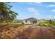 Backyard view showcasing the home's exterior with a patio and green lawn at 9127 Players Dr, Weeki Wachee, FL 34613