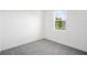 Minimalist room with a bright window overlooking a scenic view, providing a serene living space at 9127 Players Dr, Weeki Wachee, FL 34613