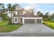 Beautiful single-story home with a gray brick driveway, stone accents, manicured lawn, and a two-car garage at 9127 Players Dr, Weeki Wachee, FL 34613