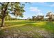 Scenic golf course view featuring lush green fairways, mature trees, and a bright blue sky at 9127 Players Dr, Weeki Wachee, FL 34613