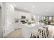 Beautiful kitchen with an island, tile floors, stainless steel appliances, white cabinets, and stools at 9127 Players Dr, Weeki Wachee, FL 34613