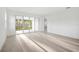 Bright living room features sliding glass doors that let in natural light and offer an outdoor view at 9127 Players Dr, Weeki Wachee, FL 34613