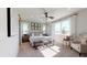 Serene main bedroom with a neutral color palette, large windows, and a stylish ceiling fan at 9127 Players Dr, Weeki Wachee, FL 34613