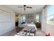 Spacious main bedroom with tufted headboard, ensuite bath, and plenty of natural light at 9127 Players Dr, Weeki Wachee, FL 34613