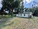 Expansive backyard showcasing a well-maintained lawn and mature trees, offering privacy and shade at 390 Hazel Cir, Punta Gorda, FL 33982