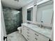 Luxurious bathroom with a walk in shower and a marble vanity with dual sinks at 390 Hazel Cir, Punta Gorda, FL 33982