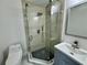 Modern bathroom featuring a glass-enclosed shower with sleek fixtures and a stylish blue vanity at 390 Hazel Cir, Punta Gorda, FL 33982