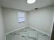 Small bedroom with marble tile flooring, white walls and a new window with blinds at 390 Hazel Cir, Punta Gorda, FL 33982