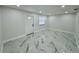 Bright and airy bedroom with marble tile floors and a white door with a window at 390 Hazel Cir, Punta Gorda, FL 33982