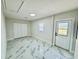 Bright bedroom with marble floors, a double closet, and a large door at 390 Hazel Cir, Punta Gorda, FL 33982