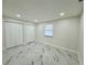 Clean bedroom features marble tile floors, white walls and new closet doors at 390 Hazel Cir, Punta Gorda, FL 33982