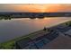 Stunning sunset reflecting over the water, with views of the screened pools and homes of the neighborhood at 14553 Eagle Branch Dr, Nokomis, FL 34275