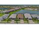 Scenic aerial view of homes in a beautiful community with mature landscaping, ponds, and tile roofs at 14553 Eagle Branch Dr, Nokomis, FL 34275