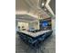 Modern bar area with granite countertop, seating, and a large TV screen at 14553 Eagle Branch Dr, Nokomis, FL 34275