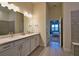 Modern bathroom with dual sinks, white cabinets, quartz countertops, and tiled floors at 14553 Eagle Branch Dr, Nokomis, FL 34275