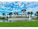 Elegant gated community entrance, featuring a fountain, lush landscaping, and picturesque water feature at 14553 Eagle Branch Dr, Nokomis, FL 34275