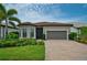 Charming single-Gathering home featuring a tile roof, manicured lawn, and well-maintained landscaping at 14553 Eagle Branch Dr, Nokomis, FL 34275