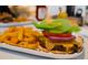 Close up of a juicy cheeseburger and crinkle-cut fries served at the restaurant at 14553 Eagle Branch Dr, Nokomis, FL 34275
