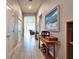 Inviting hallway with tile flooring, neutral walls, and elegant decor, leading to a bright living space at 14553 Eagle Branch Dr, Nokomis, FL 34275