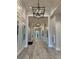 Long hallway featuring hardwood floors, paneled walls, and designer lighting fixtures for a luxurious feel at 14553 Eagle Branch Dr, Nokomis, FL 34275