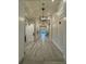 Hallway featuring hardwood floors, paneled walls, and designer lighting fixtures for a luxurious feel at 14553 Eagle Branch Dr, Nokomis, FL 34275