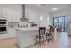 Bright, open kitchen with white cabinets, stainless steel appliances, and an island with bar seating at 14553 Eagle Branch Dr, Nokomis, FL 34275