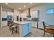 White kitchen featuring stainless appliances, gray subway tile backsplash and eat in island at 14553 Eagle Branch Dr, Nokomis, FL 34275