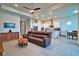 Open-concept living room and kitchen with modern appliances, neutral walls, and great natural light at 14553 Eagle Branch Dr, Nokomis, FL 34275