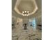 An elegant lobby with marble floors and a modern chandelier at 14553 Eagle Branch Dr, Nokomis, FL 34275
