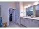Spacious bathroom featuring dual sinks, tiled shower, and walk-in closet at 14553 Eagle Branch Dr, Nokomis, FL 34275