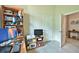 Bright office space features a bookcase, desk with computer, and natural light at 14553 Eagle Branch Dr, Nokomis, FL 34275