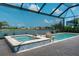 Resort-style backyard with a screened-in pool, spa, and scenic water view at 14553 Eagle Branch Dr, Nokomis, FL 34275