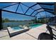 A relaxing screened-in pool and hot tub overlook a serene water view, perfect for outdoor enjoyment at 14553 Eagle Branch Dr, Nokomis, FL 34275