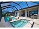Inviting pool area featuring a pool, hot tub, and ample patio space for relaxation at 14553 Eagle Branch Dr, Nokomis, FL 34275