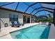 Inviting pool and patio area with outdoor seating, grill, and scenic views at 14553 Eagle Branch Dr, Nokomis, FL 34275