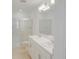Bright bathroom featuring double sinks, white cabinets, and a glass-enclosed shower at 8540 Daybreak St, Sarasota, FL 34241