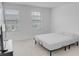 Bright bedroom featuring two windows, neutral walls, and carpet flooring at 8540 Daybreak St, Sarasota, FL 34241