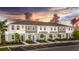 New construction townhomes with modern facades, bright blue doors, and meticulous landscaping at 8540 Daybreak St, Sarasota, FL 34241