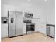 Bright kitchen with stainless steel appliances, white cabinets, and tile flooring at 8540 Daybreak St, Sarasota, FL 34241