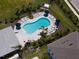 Aerial view of a community pool surrounded by lounge chairs and lush landscaping at 8540 Daybreak St, Sarasota, FL 34241