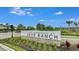 The Townhomes at Skye Ranch community sign, with lush landscaping against a bright blue sky at 8540 Daybreak St, Sarasota, FL 34241