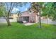 Large backyard with lush green grass, a cozy patio set, and a privacy fence at 6932 Gray Catbird Loop, Wesley Chapel, FL 33545
