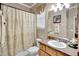 Bathroom featuring a shower-tub combo with a decorative shower curtain at 6932 Gray Catbird Loop, Wesley Chapel, FL 33545